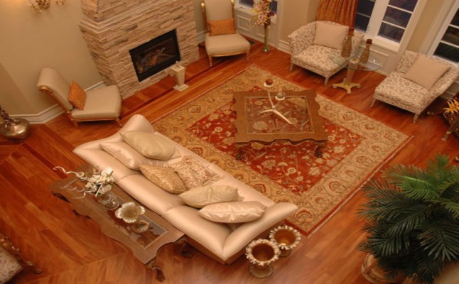 luxury living room with brown wooden floor and custom fire place