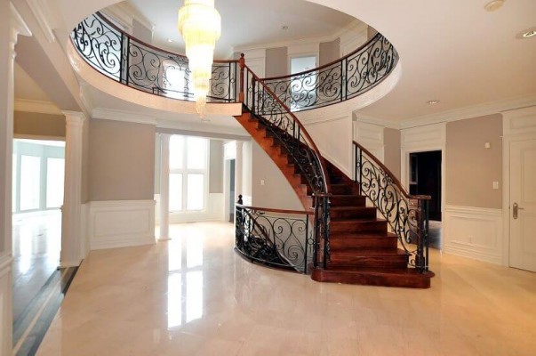 second floor staircase with wooden stairs and steel railings