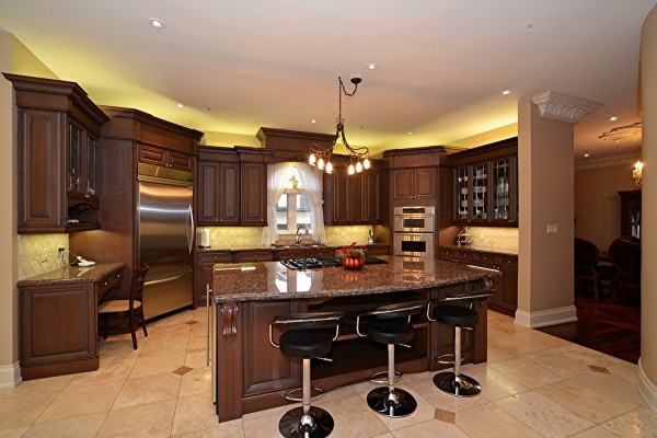 luxury kitchen with dark brown cabinets and island