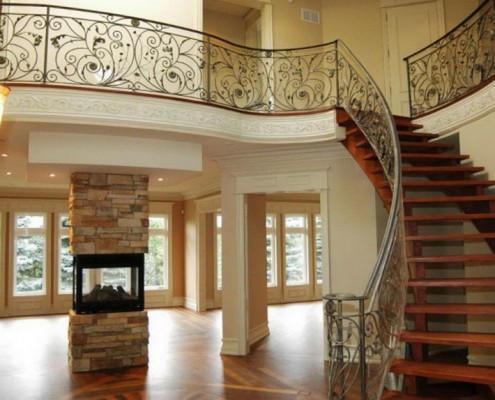 custom staircase to second floor and fireplace